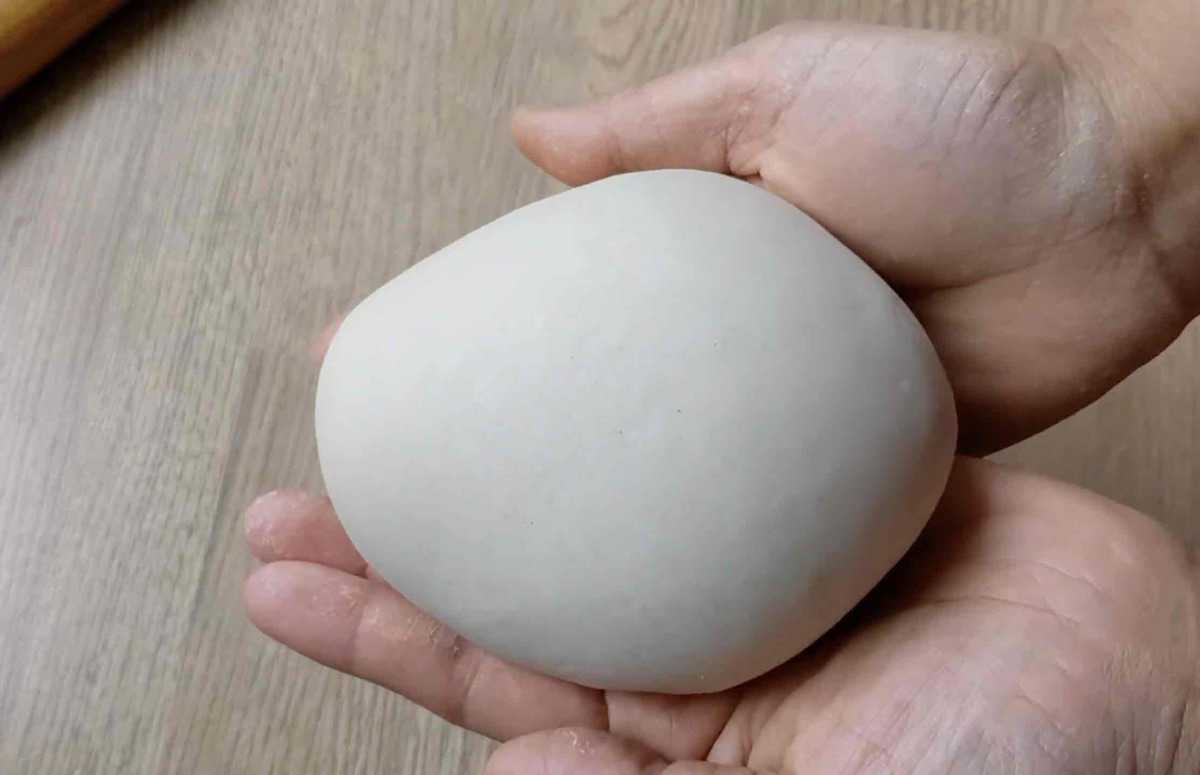 a piece of smooth dough held by hand