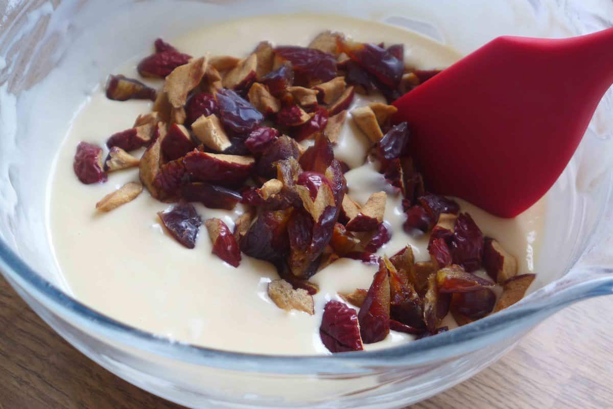 adding chopped dates to cake batter.