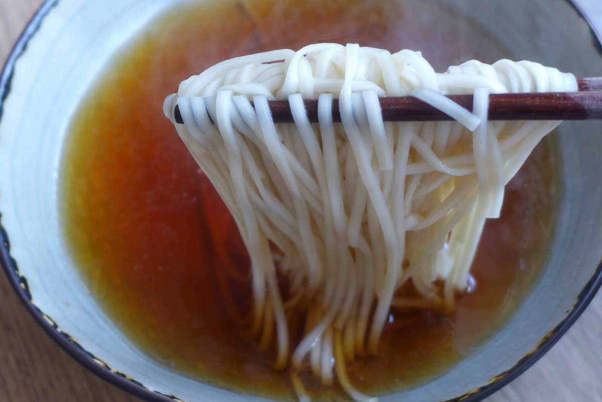 adding noodles to soup.