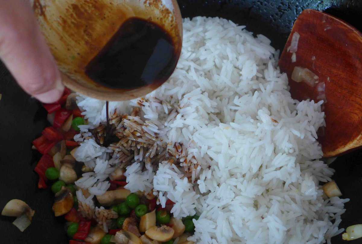 pouring sauce over rice.