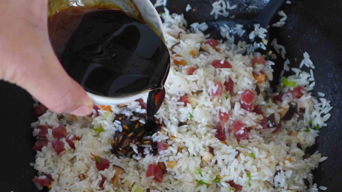 pouring sauce mixture over rice.