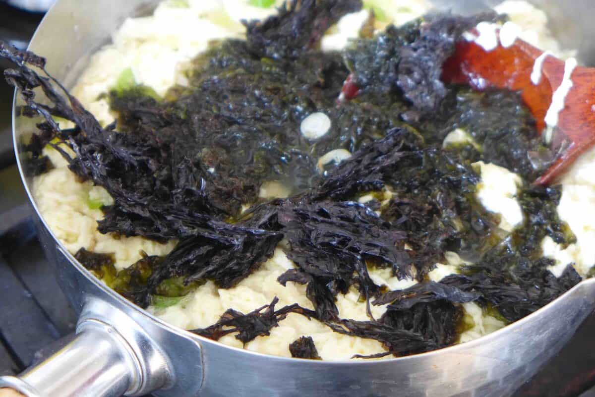 adding seaweed to egg drop soup.