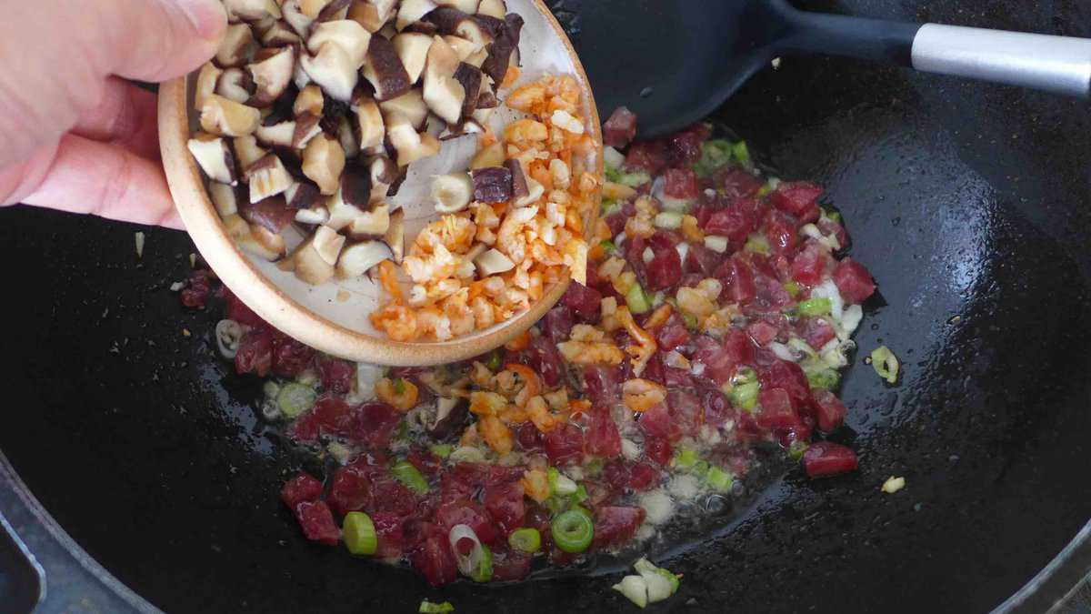 adding shiitake mushrooms and dried shrimp.