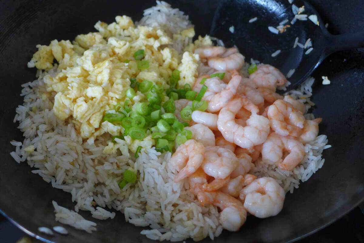 cooked shrimp and egg over fried rice.