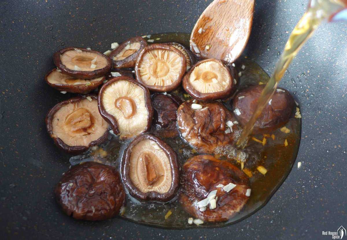 Adding mushroom soaking water to fried mushrooms
