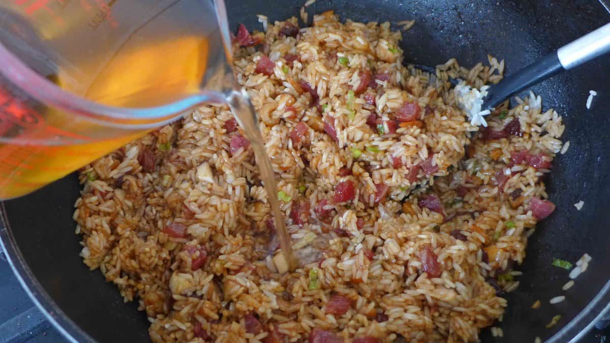 adding-liquid to stir-fried sticky rice.