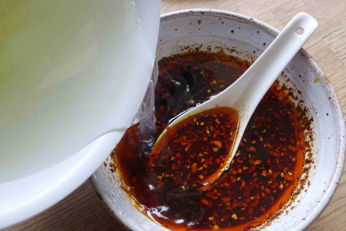 adding stock to sauce.