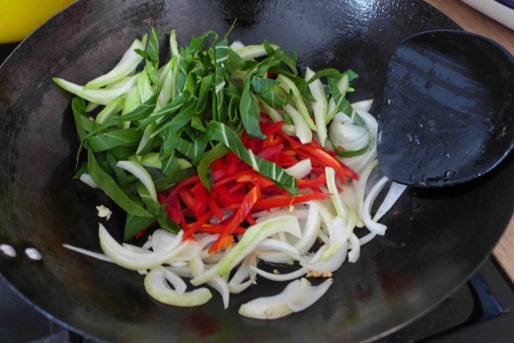 bok choy and chili pepper in wok.