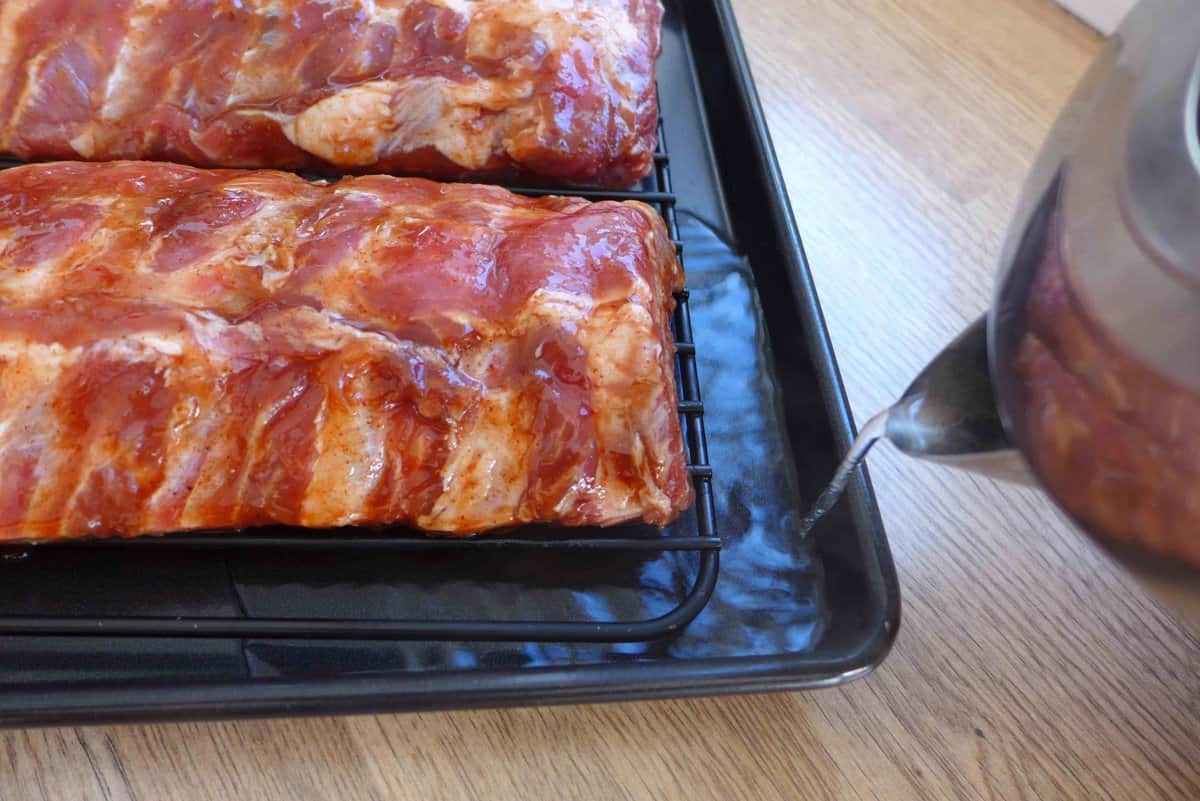 adding hot water to baking tray.