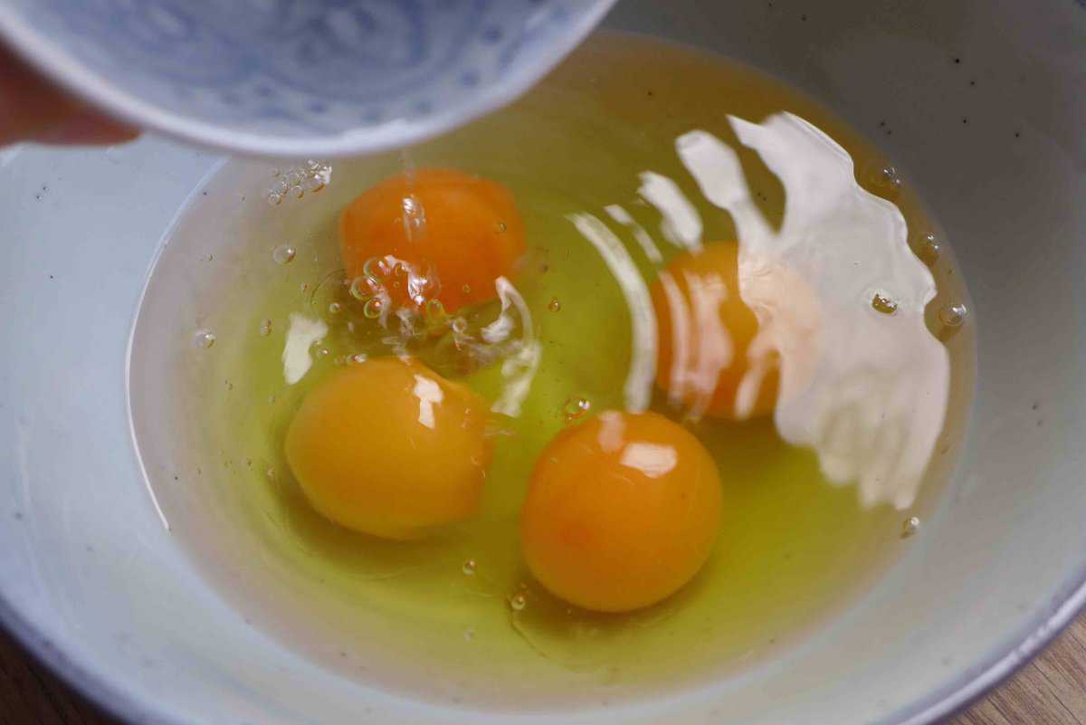 adding water to cracked eggs.