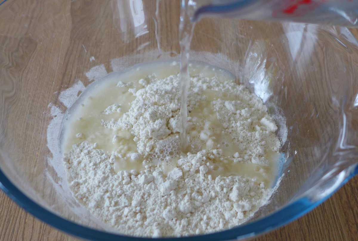 adding hot water to flour