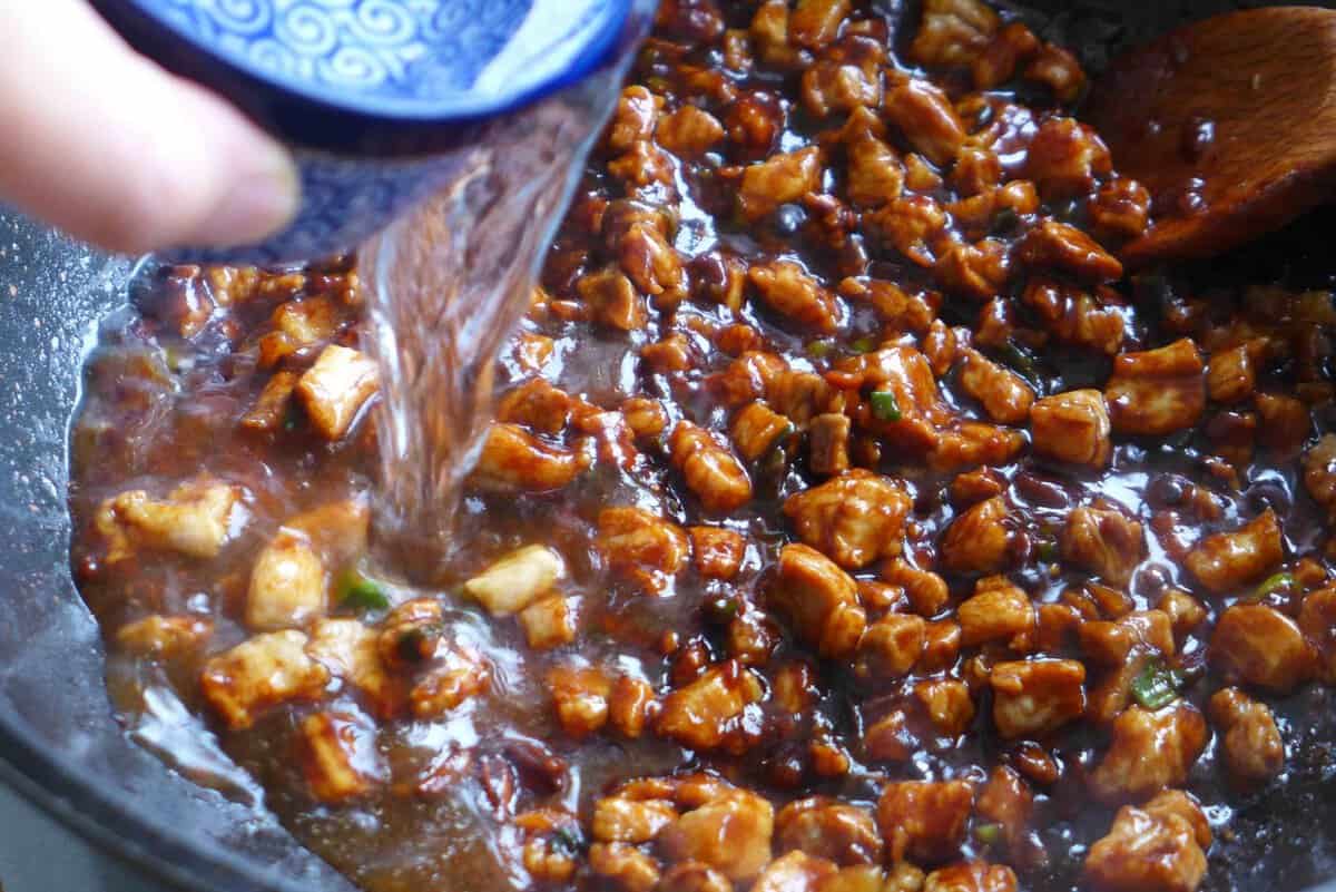 adding water to pork sauce.
