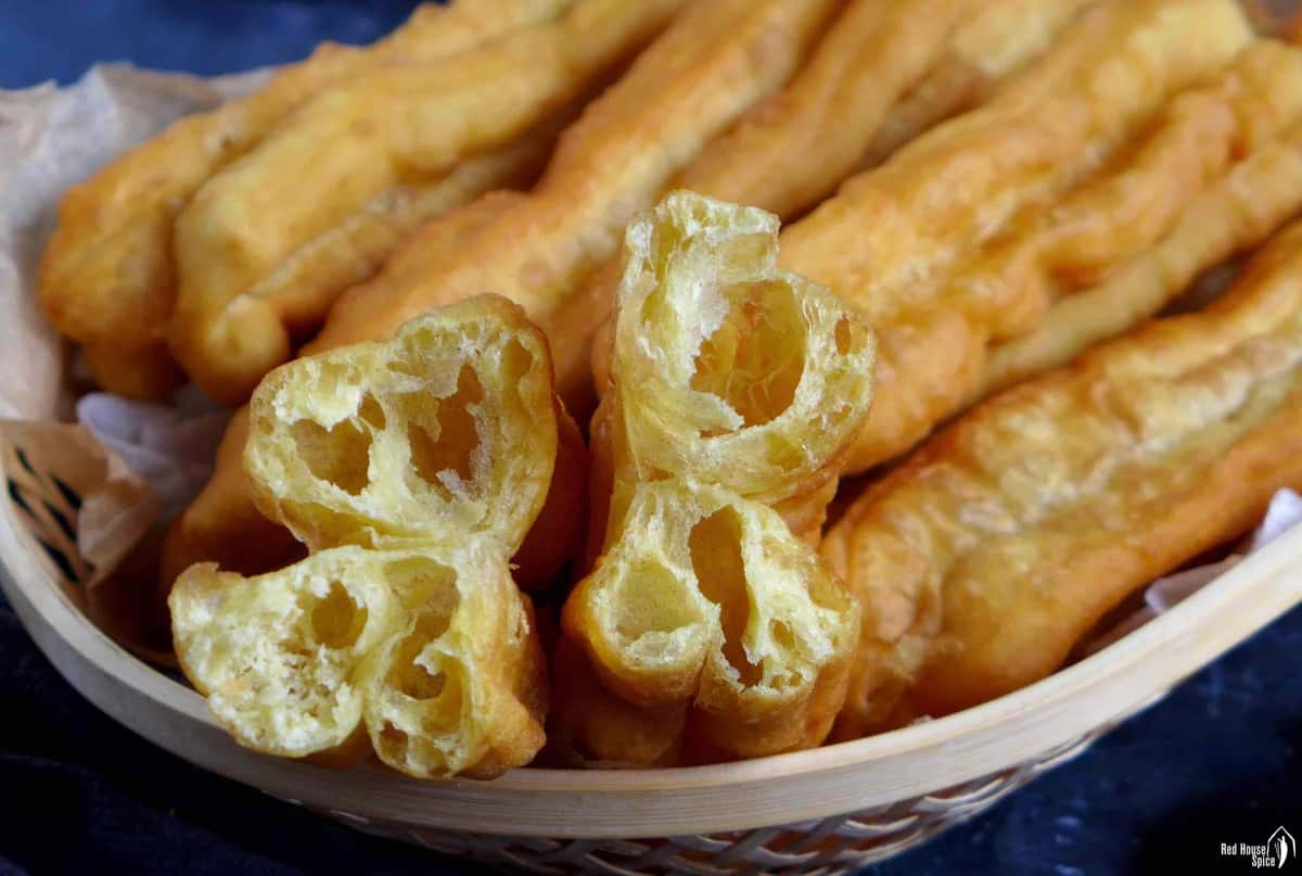 A torn open Chinese doughnut stick showing the holes inside.