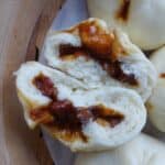 A Chinese BBQ pork bun torn in halves