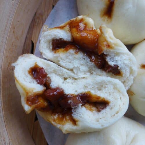 A Chinese BBQ pork bun torn in halves