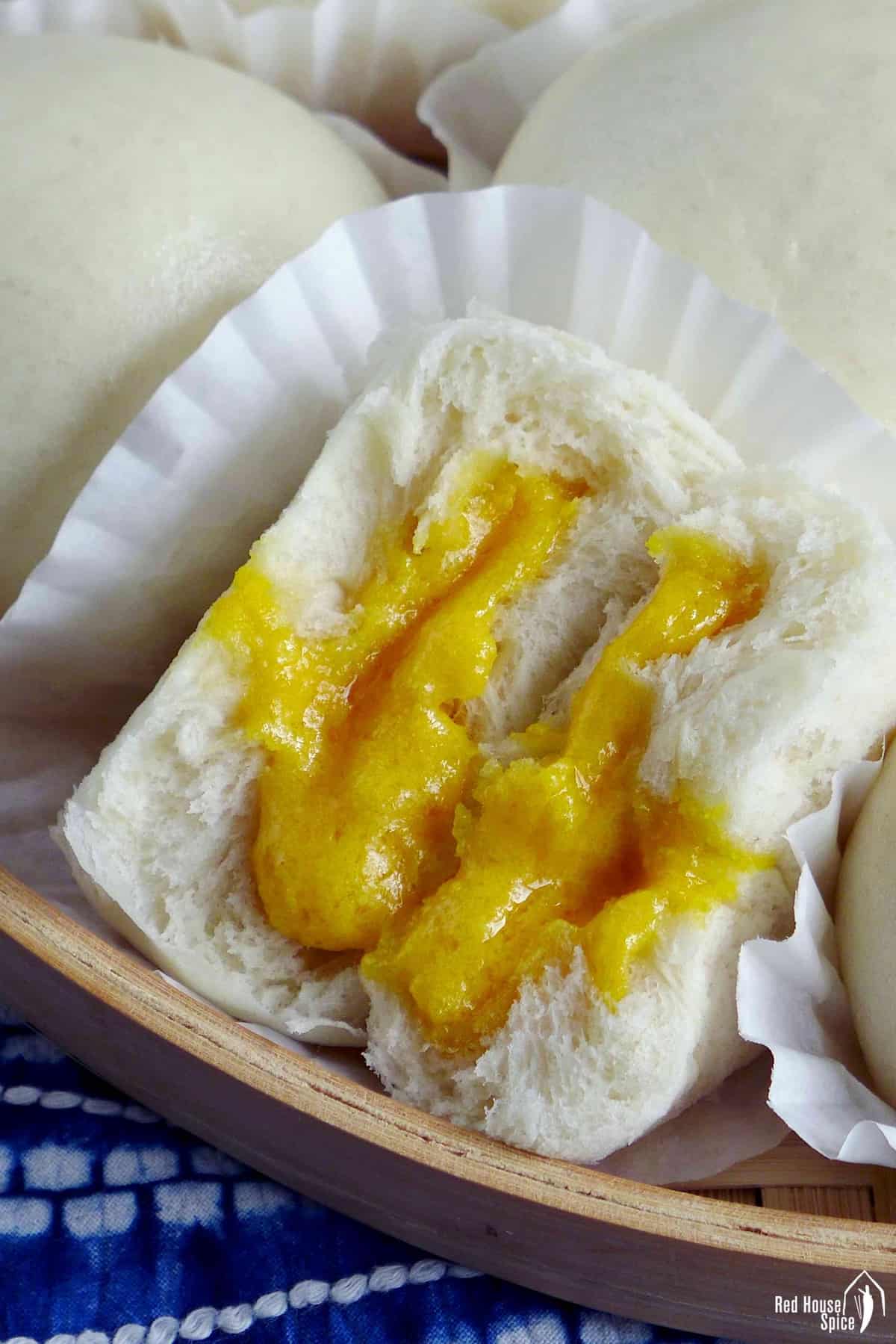 A fluffy steamed bun with semi-runny custard filling
