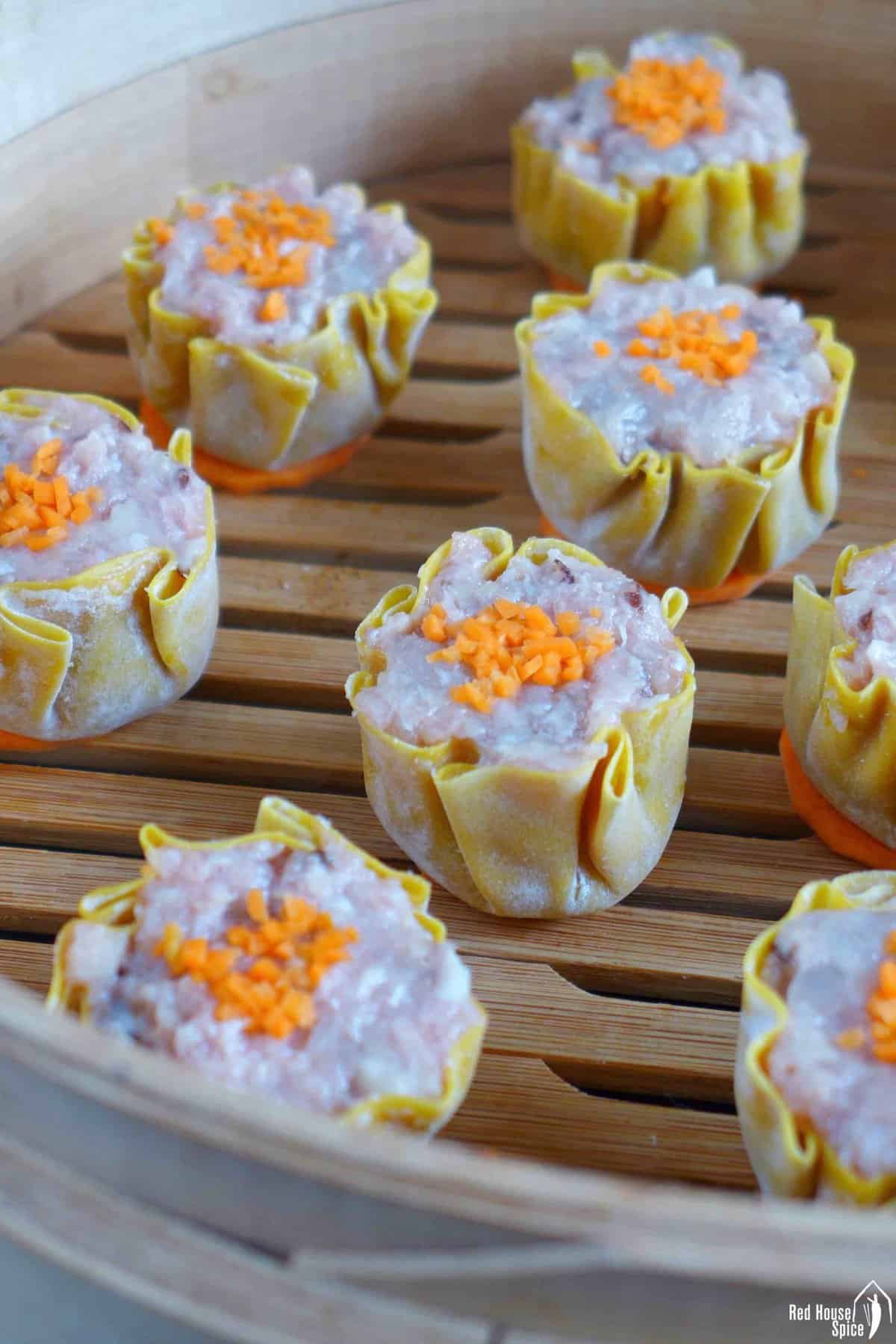 uncooked Siu Mai in a bamboo steamer basket.