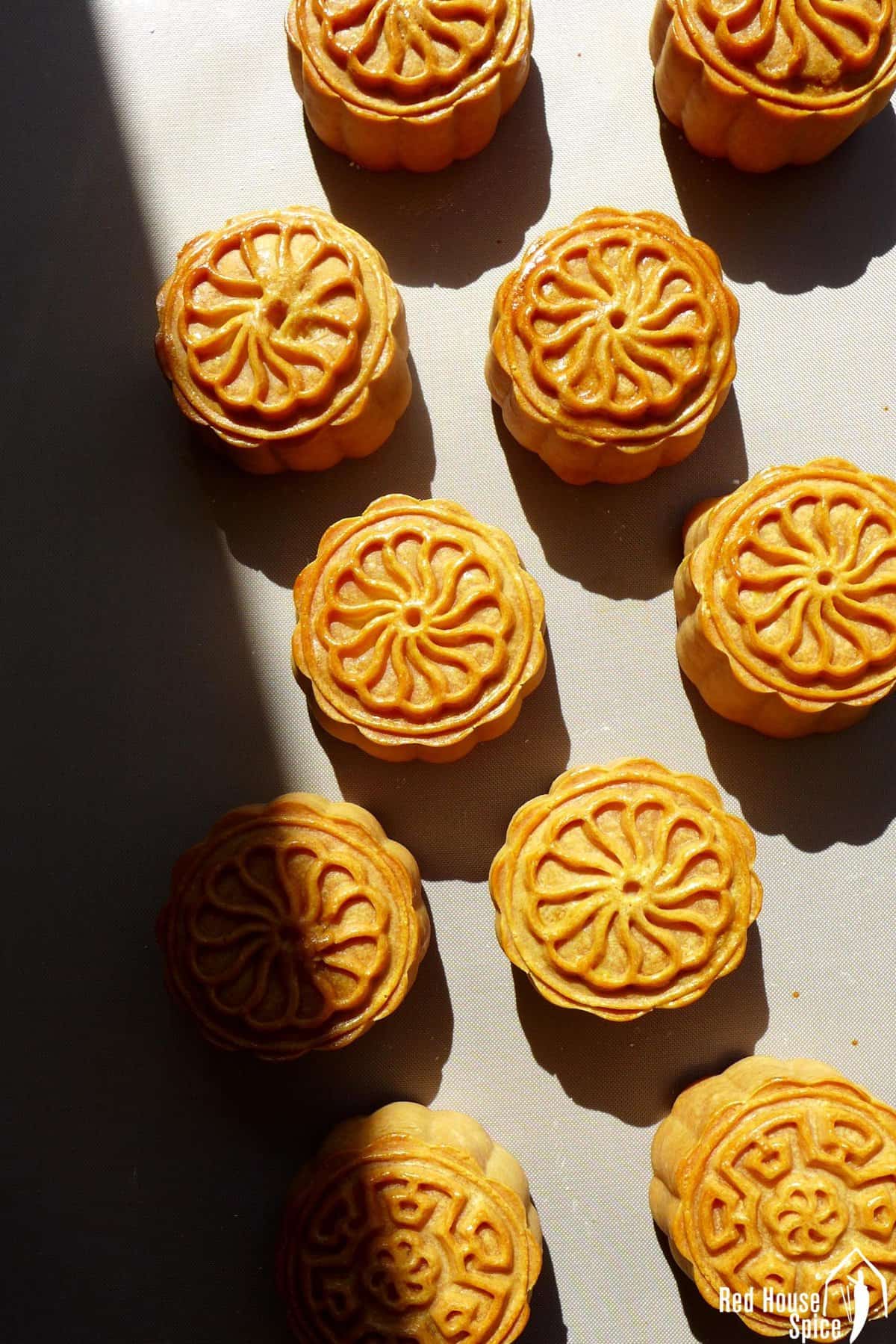 baked cantonese mooncakes on a tray.