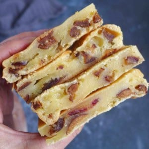 baked rice caked with dates held by hand.