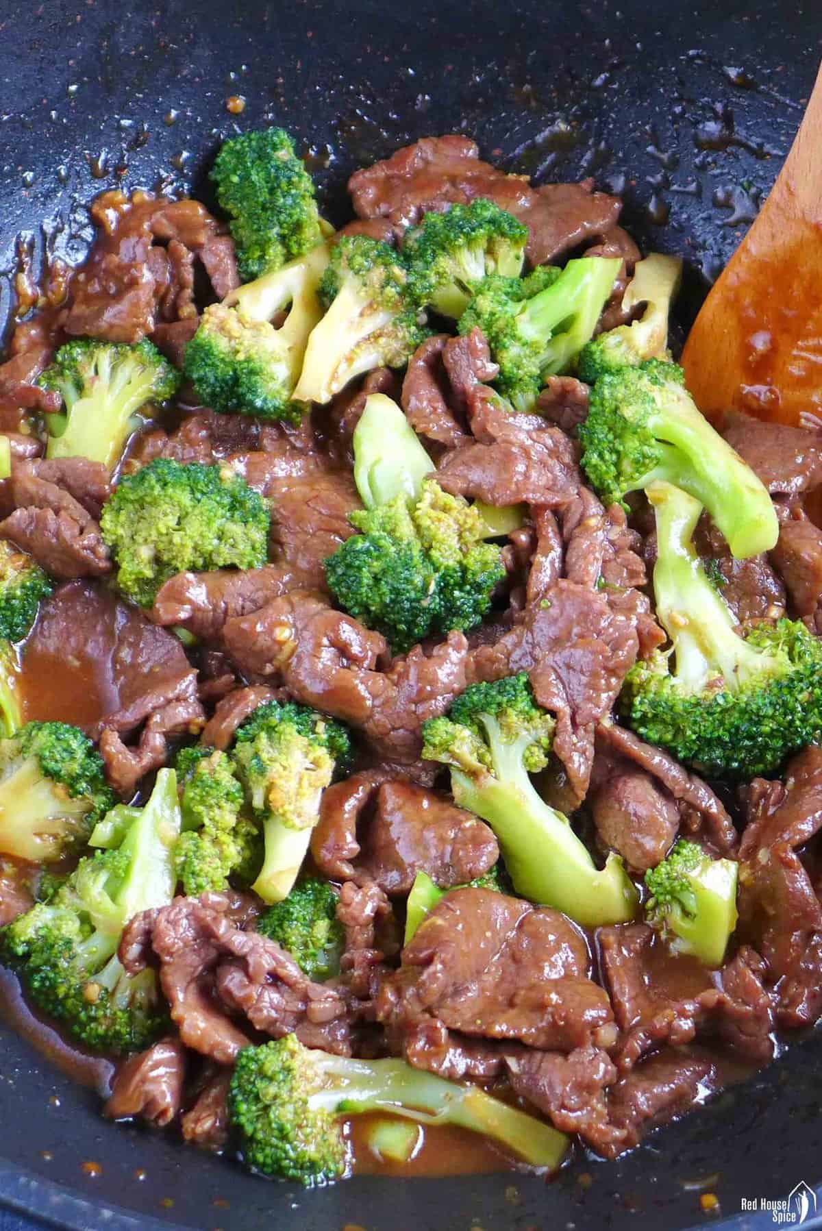 stir-frying beef and broccoli in a wok.
