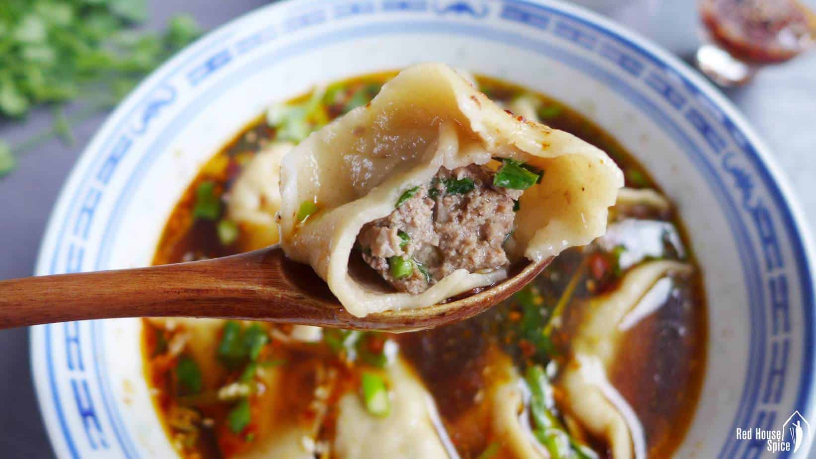 A half eaten beef dumpling.