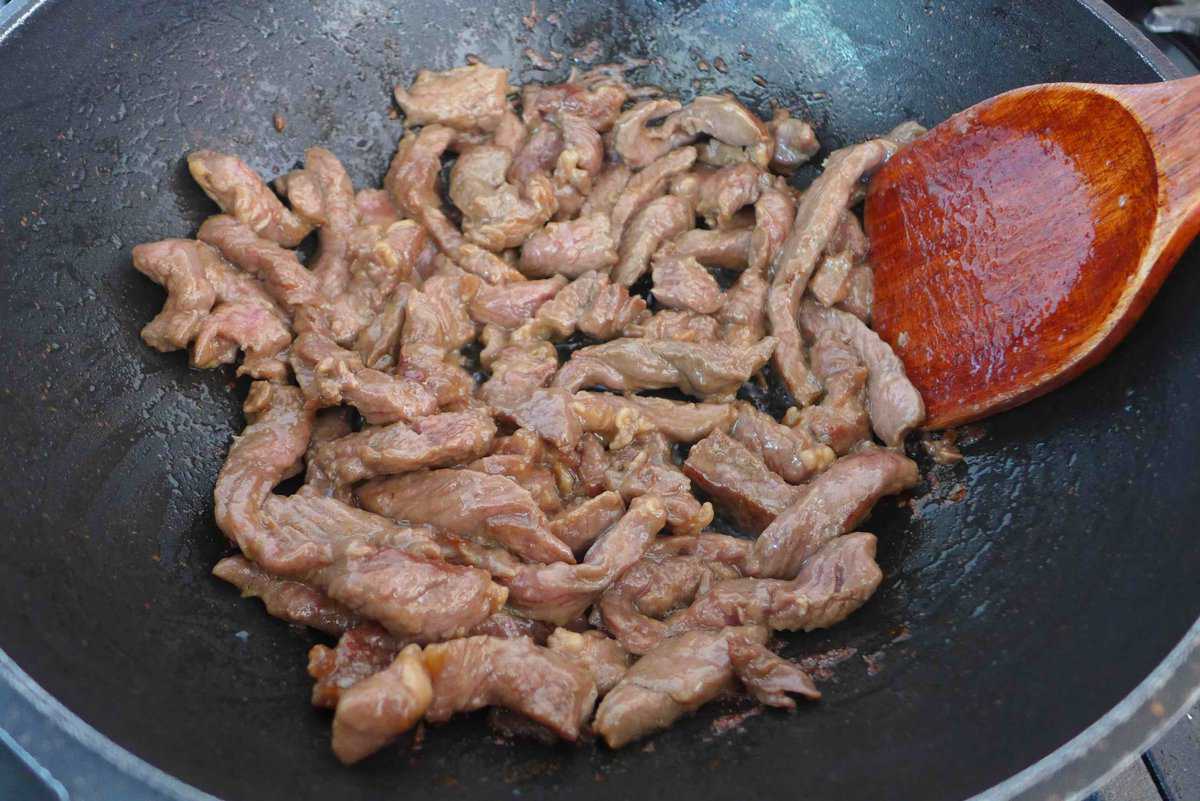 searing beef in a wok.
