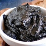 Black sesame paste in a bowl with overlay text that says black sesame paste.