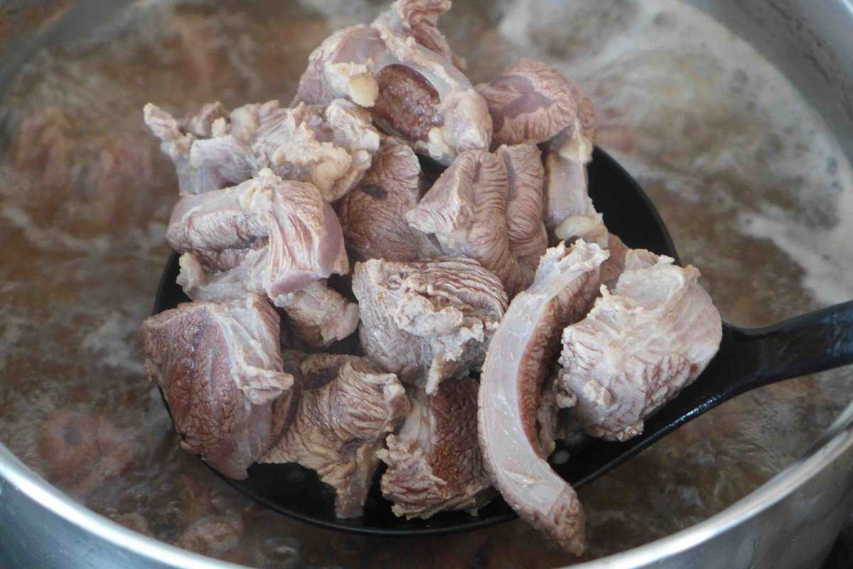 draining blanched beef chunks.