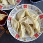 a plate of boiled pork dumplings
