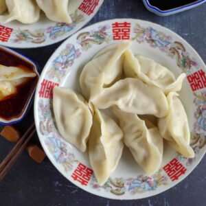 a plate of boiled pork dumplings