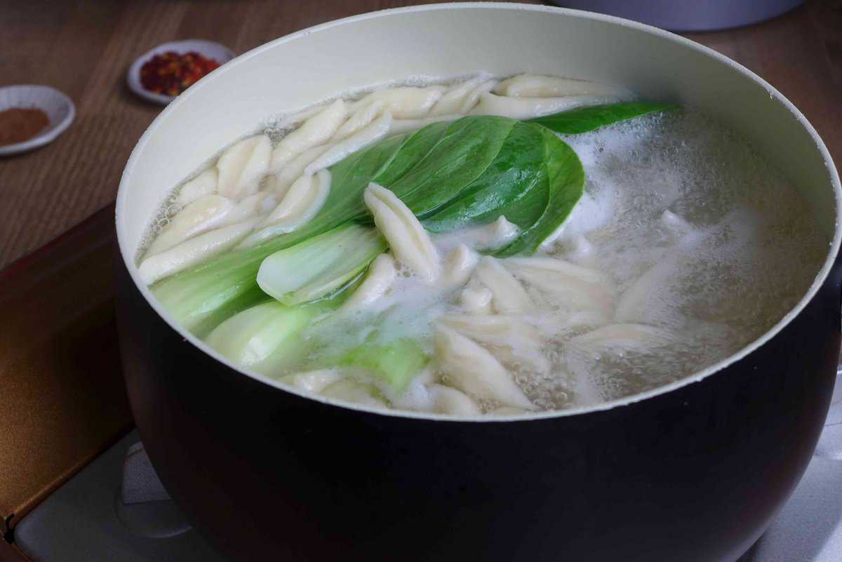 boiling scissor cut noodles and Bok Choy