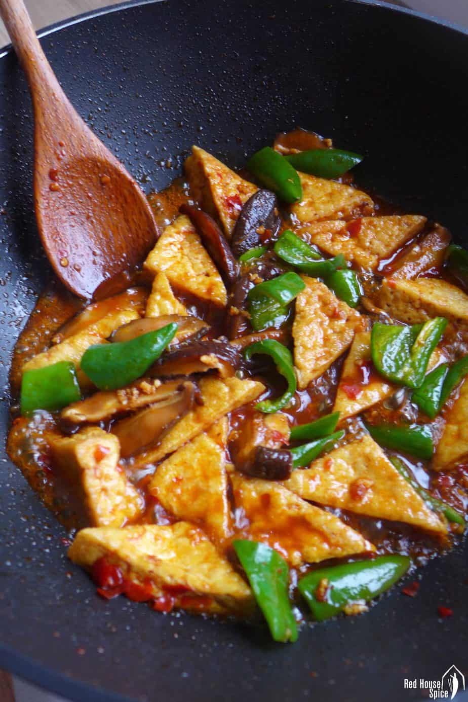 braising fried tofu in a wok