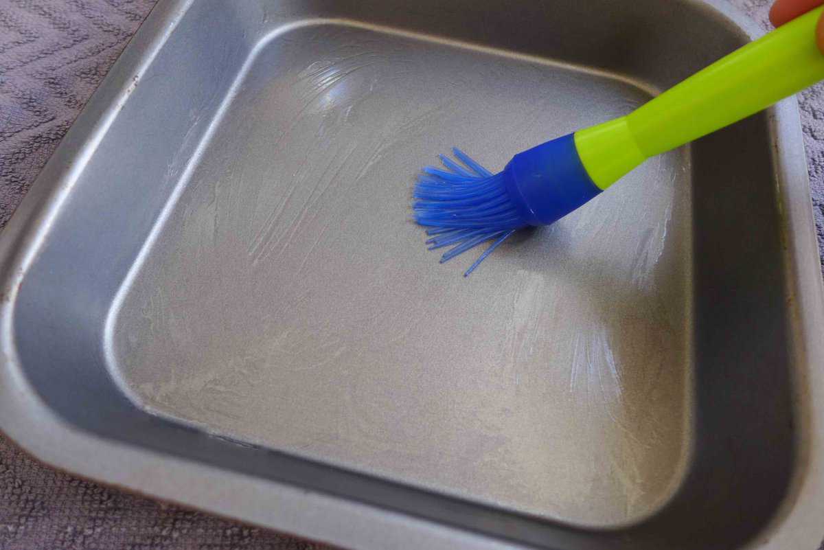 brushing oil over a tray