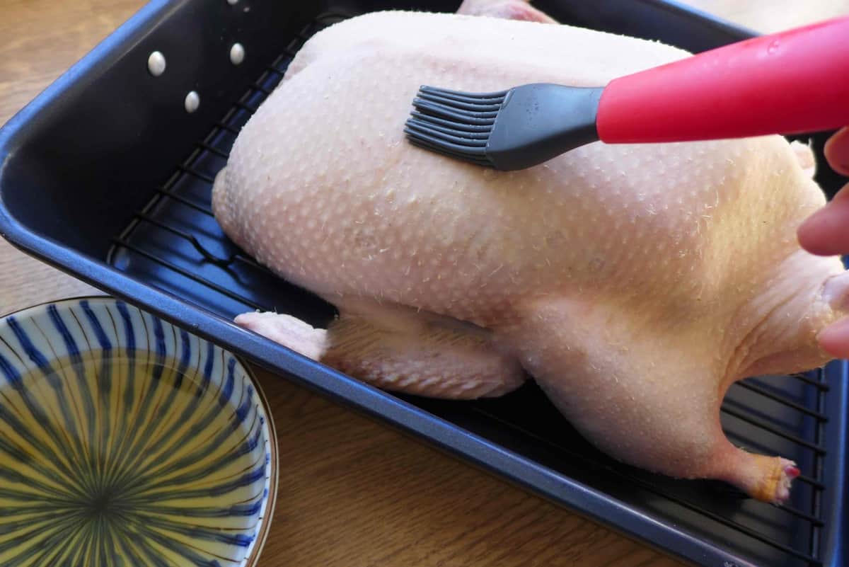 brushing syrup over duck skin