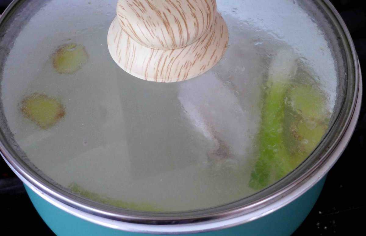 chicken in a pot with lid on.