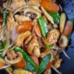 Frying chicken chop suey in a wok