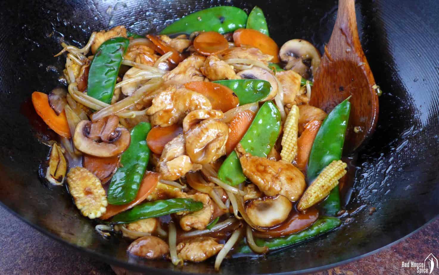 frying chicken chop suey in a wok