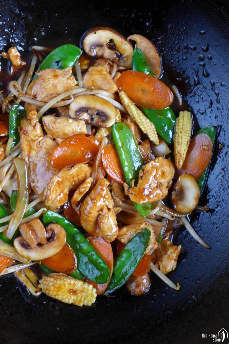 Frying chicken chop suey in a wok
