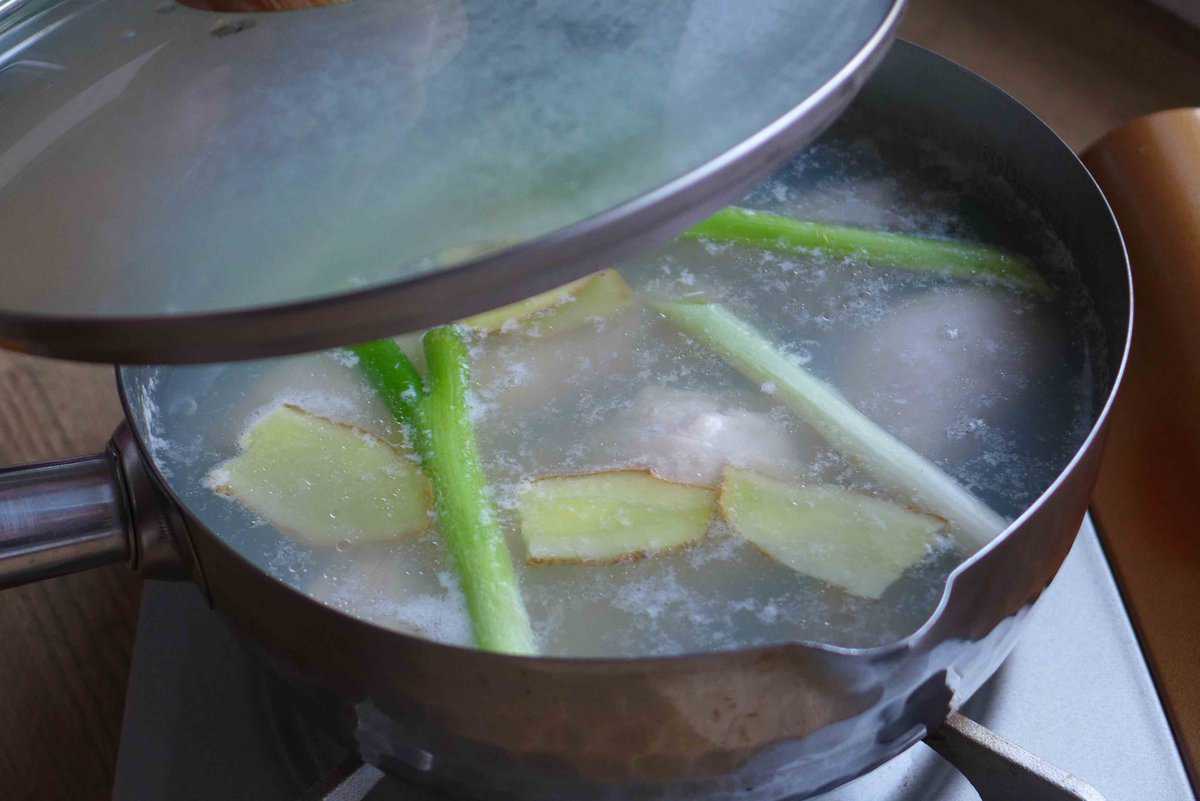 chicken in simmering water.