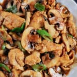 Stir-fried chicken slices and button mushrooms.