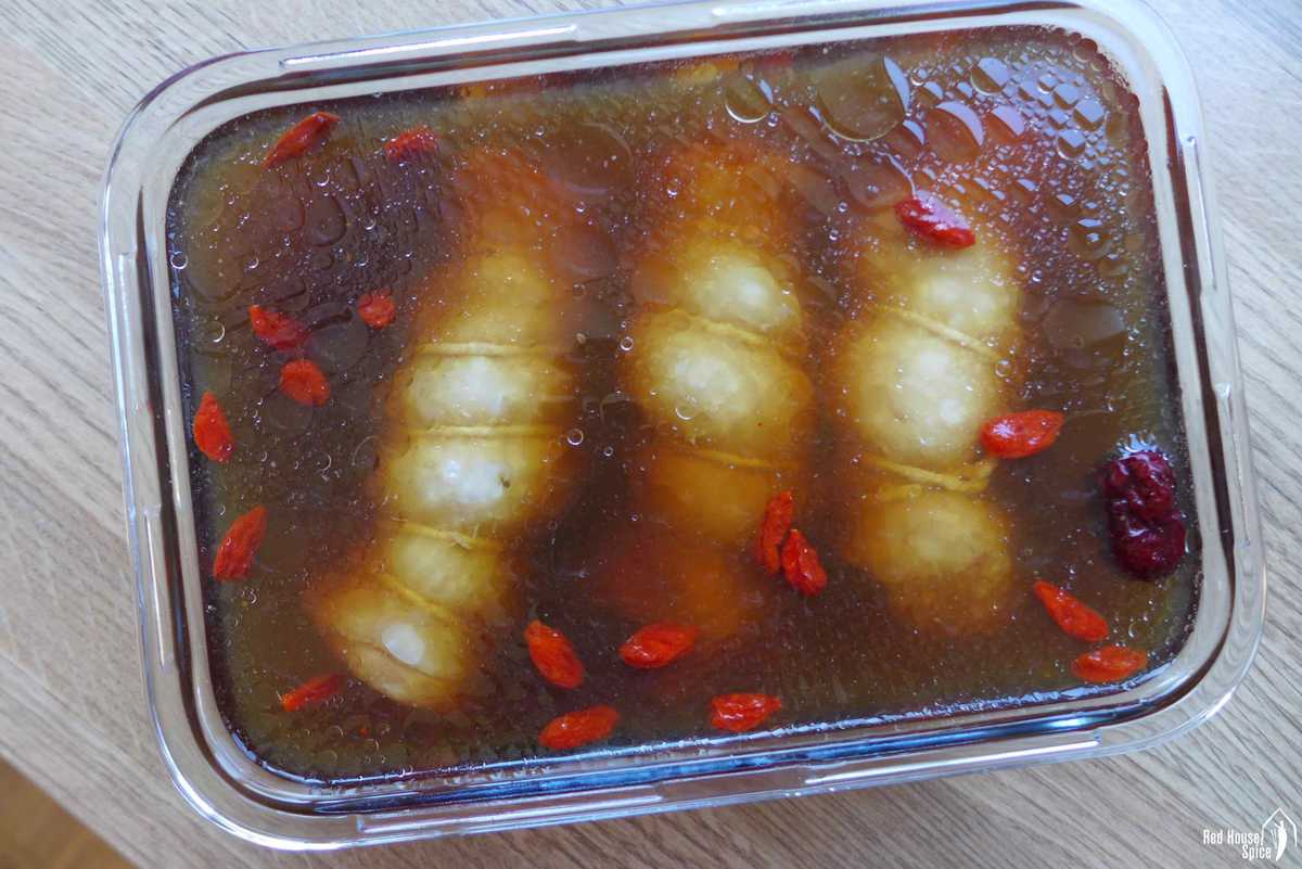 cooked chicken rolls in rice wine brine
