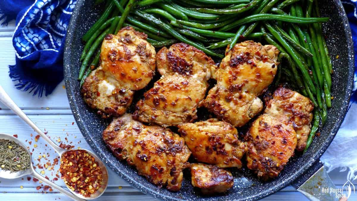 chili and cumin spiced chicken tights with green beans.
