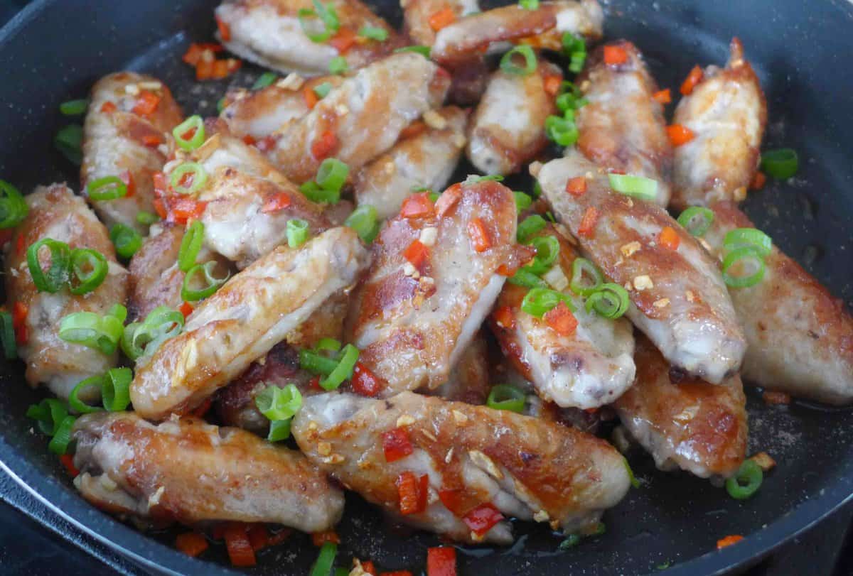 mixing chili and garlic with chicken wings.