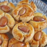 cookies with almonds in a plate with overlay text that says chinese almond cookies.