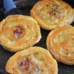 four beef stuffed flatbread in a skillet.
