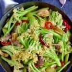 stir-fried cauliflower with pork belly with overlay text that says dry pot cauliflower.