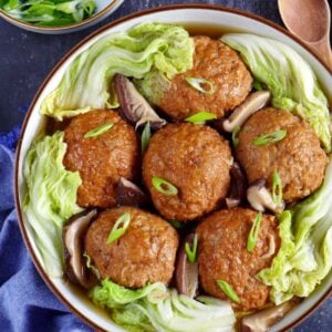 Six lion's head meatballs in a plate