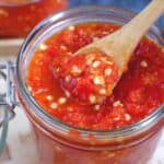 Spoon scooping out some pickled chili garlic sauce