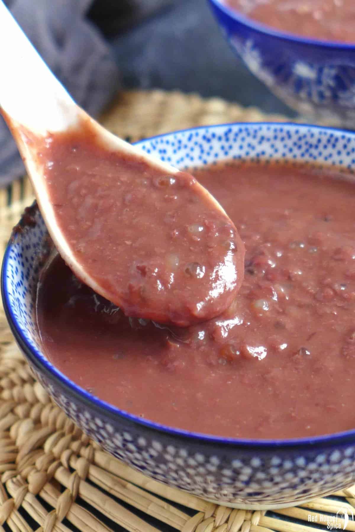 Spooning sweet red bean soup.