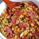 Chinese sausage rice in a saucepan with overlay text that says Chinese sausage rice.